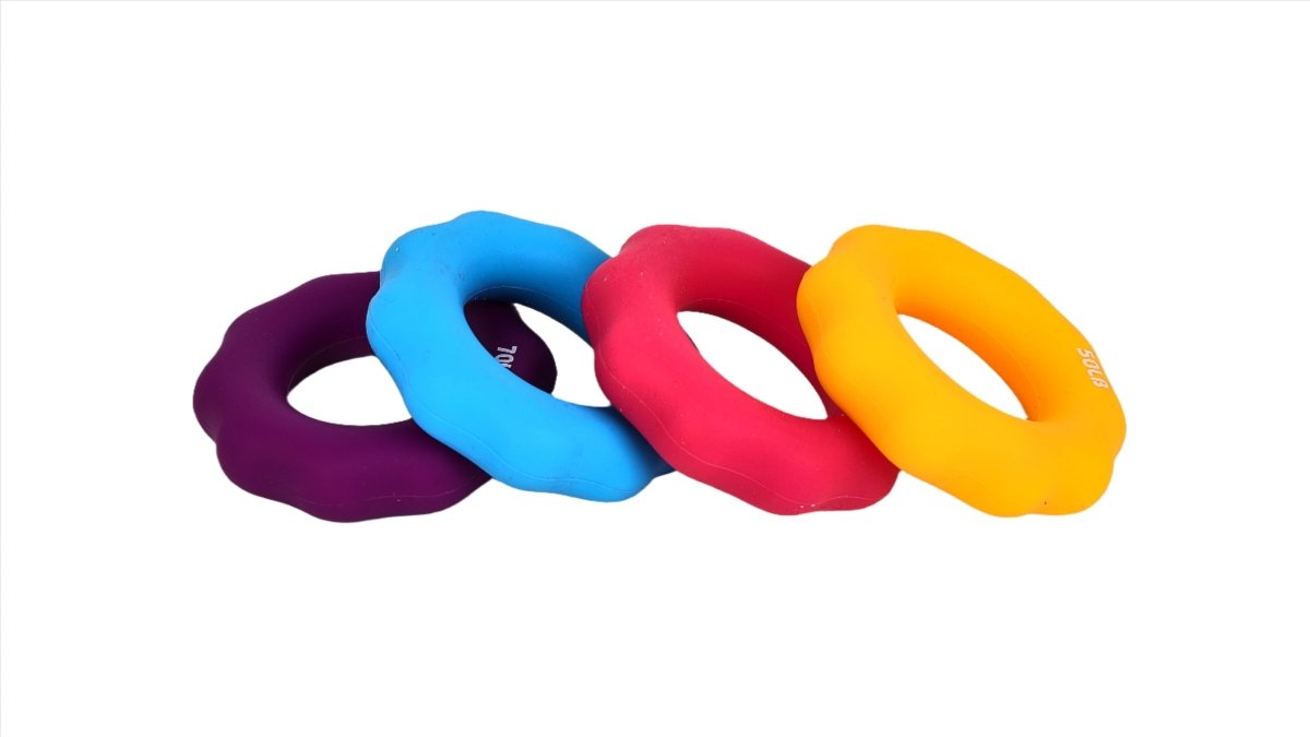 Four colorful hand gripper rings—purple, blue, red, and orange-yellow