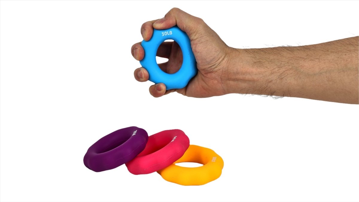 Hand holding a blue hand gripper ring; spare purple, red, and orange-yellow rings