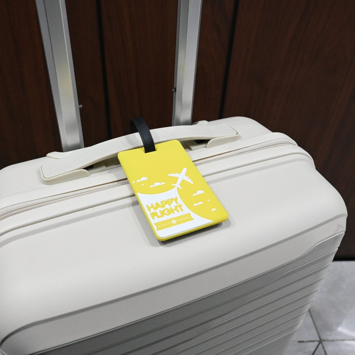 Yellow luggage tag with black strap, Happy Flight design and airplane graphics