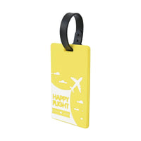 Yellow luggage tag with black handle strap and Happy Flight plane-and-cloud pattern