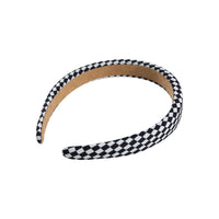 Black and white checkered headband with tan inner band, curved