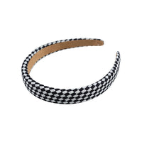 Black and white checkered headband with tan inner band, arched