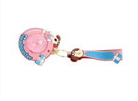 Pink dog cartoon keychain with circular glitter charm and Headmaster ribbon strap