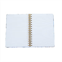 Holographic geometric notebook, open with white lined pages and gold spiral