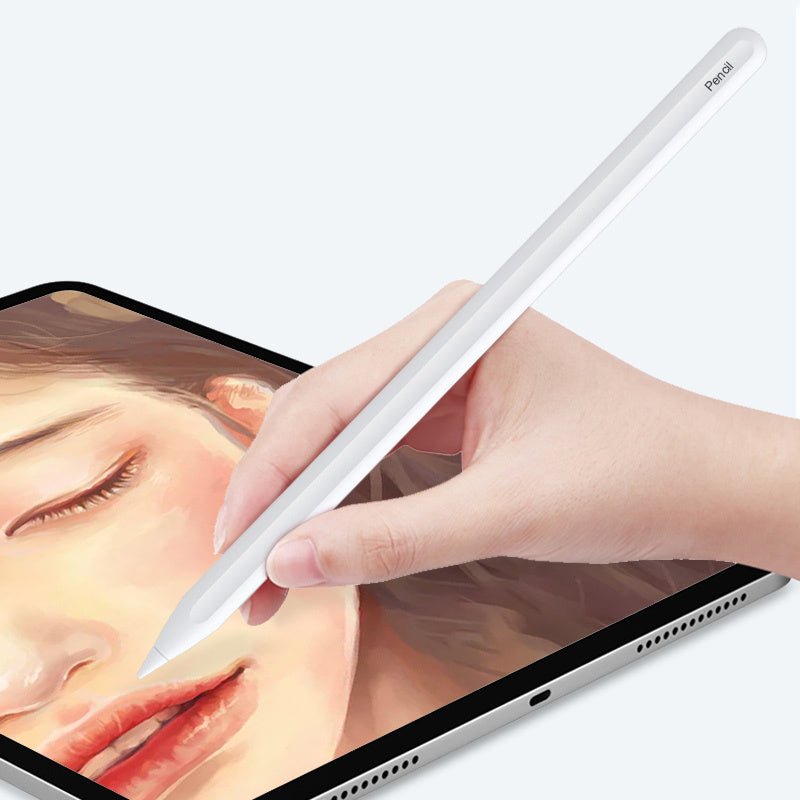 White stylus pencil held by hand, writing on tablet screen