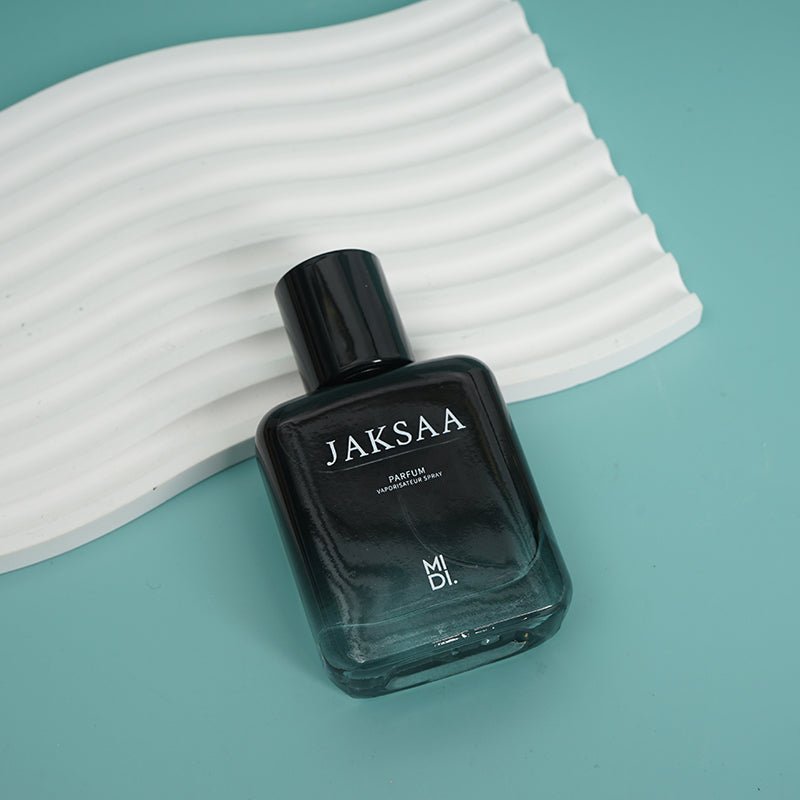 JAKSAA men's perfume bottle on white ribbed surface, black cap