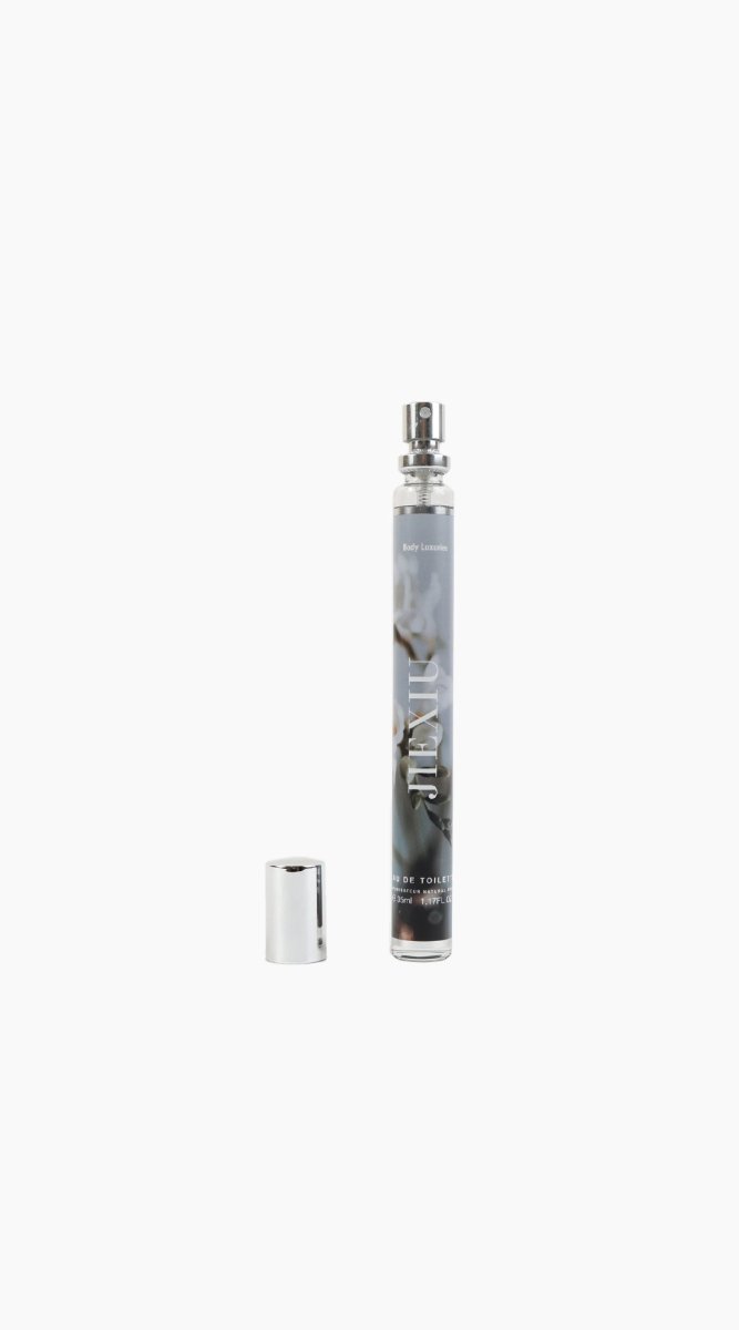 JEXIU eau de toilette spray bottle with silver cap and small metal cap.