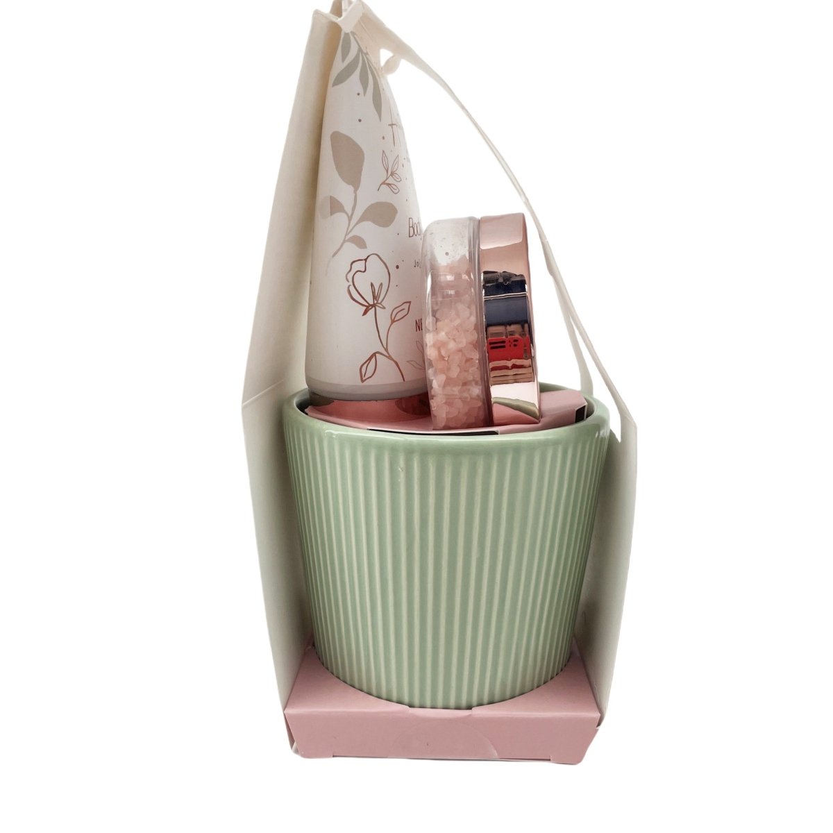 Green ribbed mug with bath salt tin and body lotion tube in a gift bag
