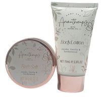 Body lotion tube beside bath salt tin with rose-gold rim; gift set containers