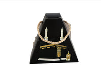 Kaaba-shaped gift box with rope handle, black and gold design, small lantern.