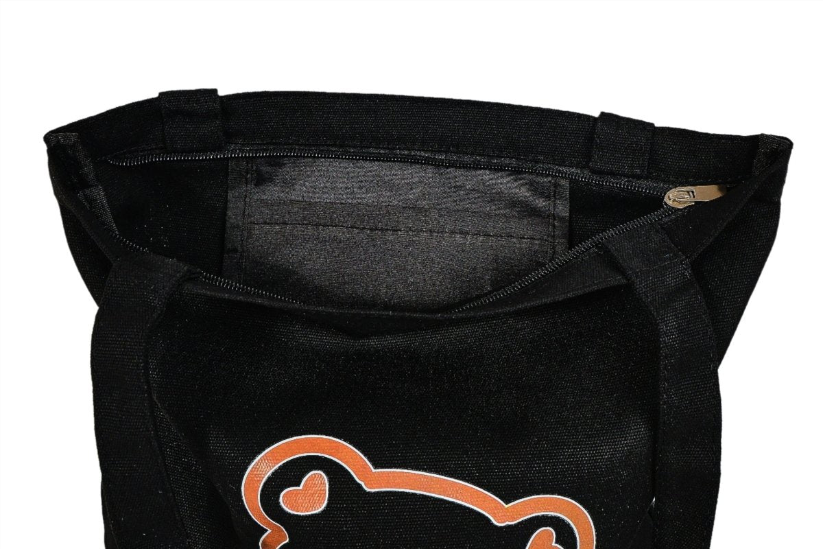 Black bear tote bag front close-up with cartoon bear print and top handle