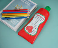Red ketchup-shaped pencil case with green cap, lying flat