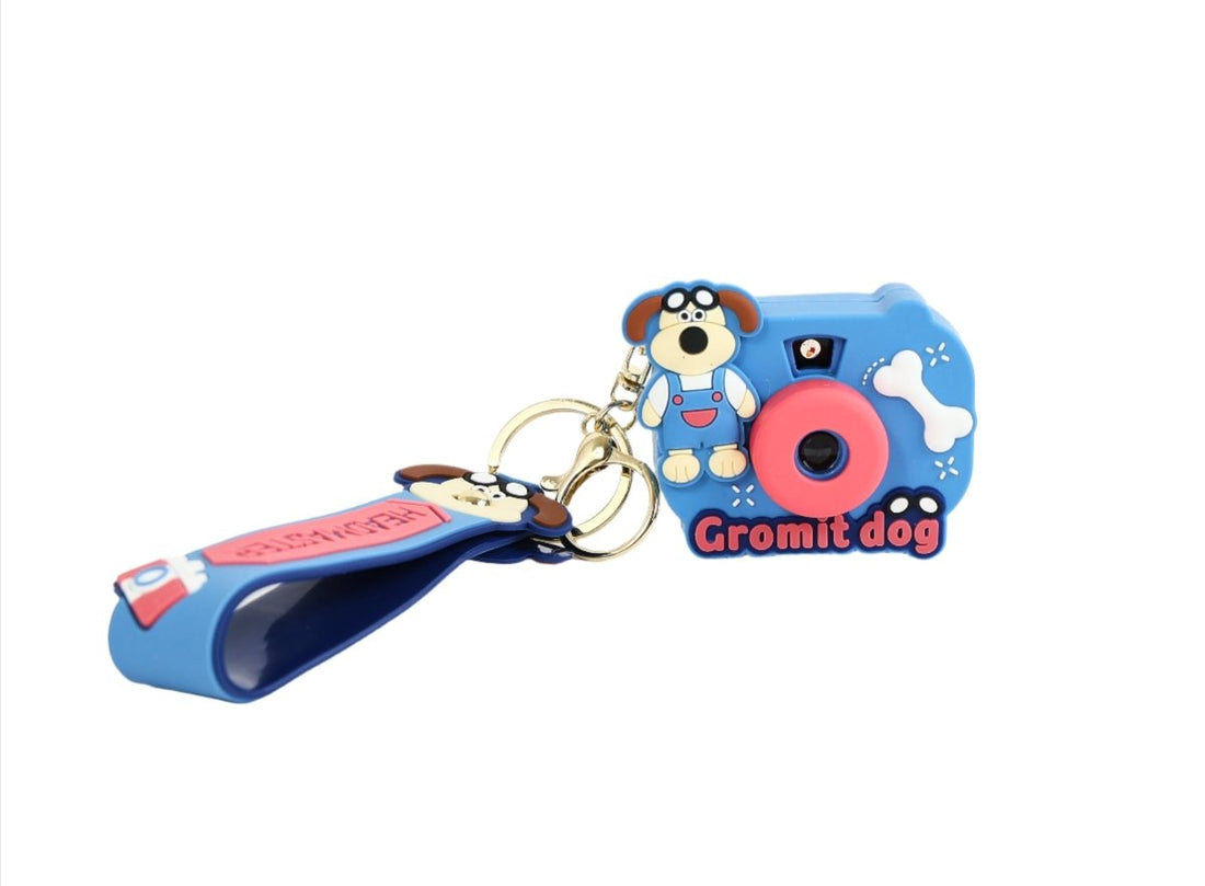 Blue silicone camera keychain with Gromit dog cartoon and pink button detail