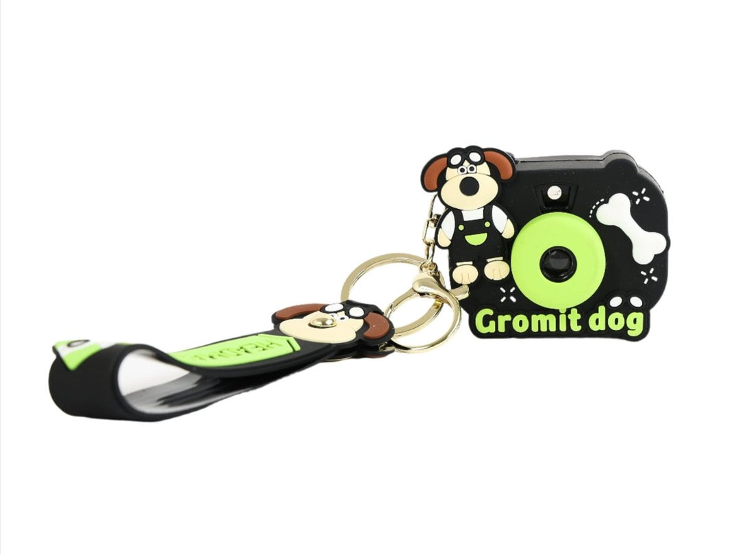 Black silicone camera keychain with Gromit dog cartoon and green ring center