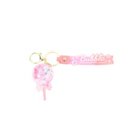Pink bubble keychain with glitter puff charm, hanging ribbon stick, and Bubble bar
