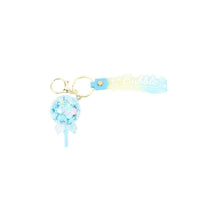 Blue bubble keychain with glitter puff charm, hanging ribbon stick, and Bubble bar