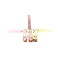 Keychain strap with three character charms and gold rings