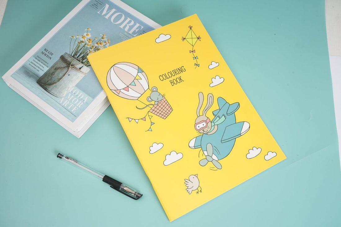 Kids coloring book with yellow cover and cute animal drawings, clouds and balloons