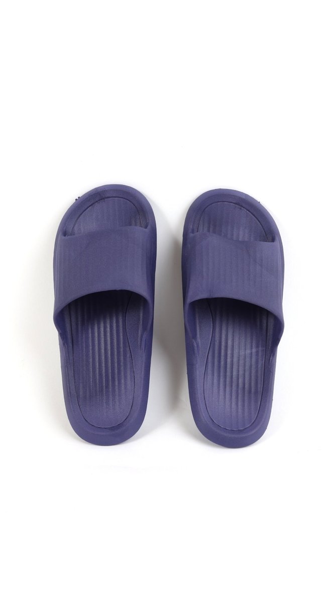 Kids deep purple slide slippers, front view with ribbed texture and slip-on opening.