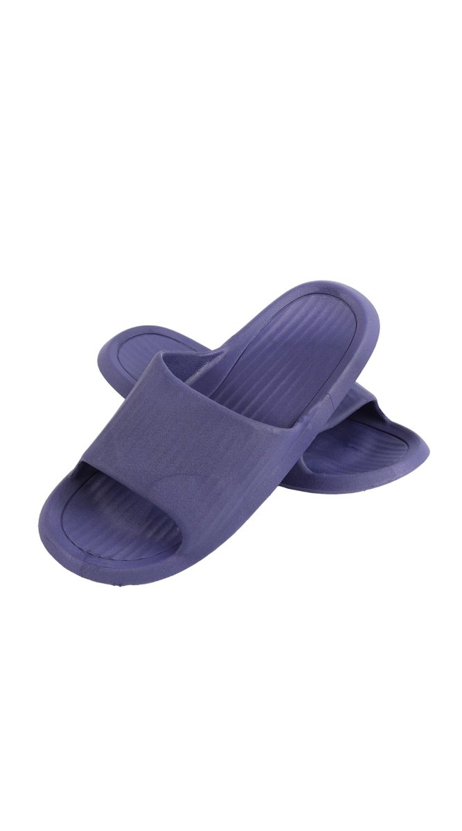 Kids deep purple slide slippers shown side angle with wide slip strap and ribbed sole.
