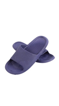 Kids deep purple slide slippers shown side angle with wide slip strap and ribbed sole.
