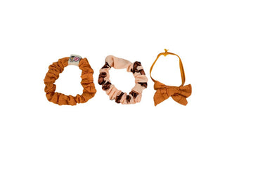 Scrunchie-style hair ties: brown/orange with small logo patch, plus dark and orange bow styles.