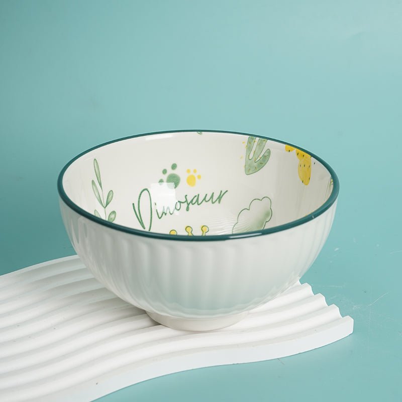 Kids dinosaur bowl, white ceramic with green dinosaur and paw-print design