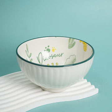 Kids dinosaur bowl, white ceramic with green dinosaur and paw-print design