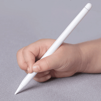 Kids electronic writing pad with stylus held in a hand