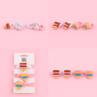 Set of cake-shaped decorative hair ties with colorful frosting and sprinkles
