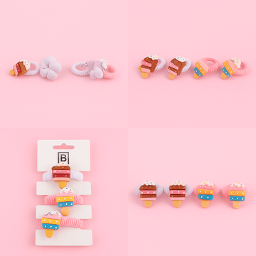 Set of cake-shaped decorative hair ties with colorful frosting and sprinkles