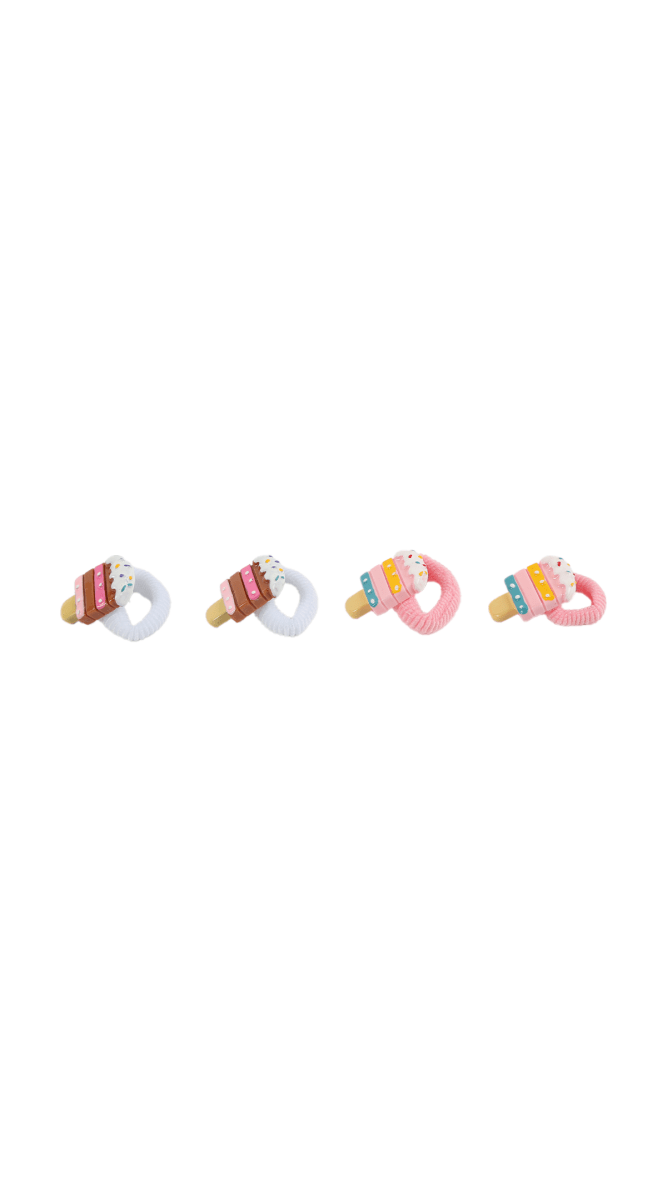 Four cake-decorated hair ties with rainbow sprinkles and elastic bands