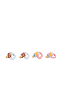 Four cake-decorated hair ties with rainbow sprinkles and elastic bands