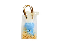 Blue towel bear in small gift bag with bow handle and straw filler