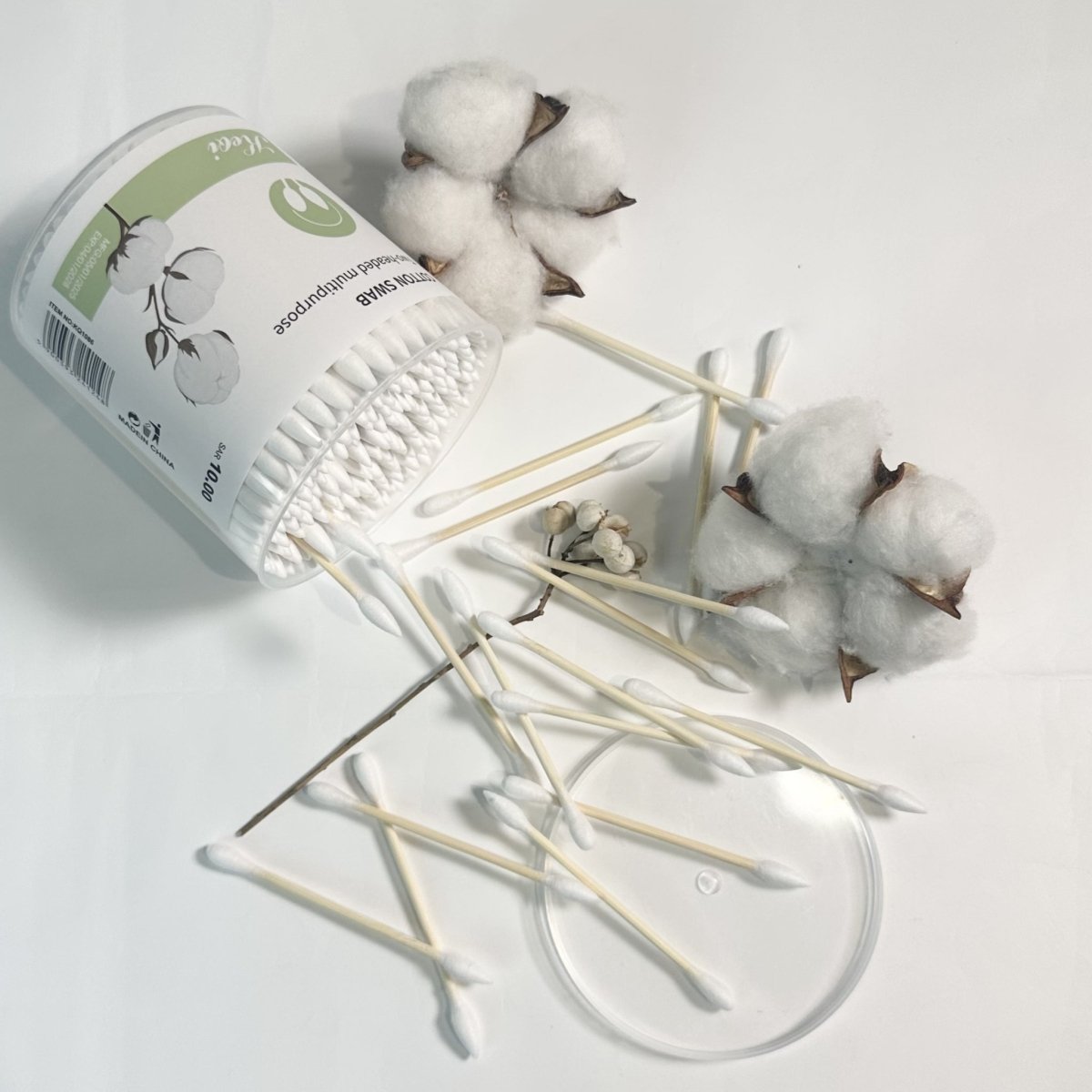 Double-headed cotton swabs spilling on tray with open jar