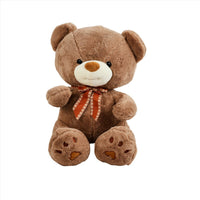 Soft brown teddy bear plush with red ribbon bow and embroidered face.