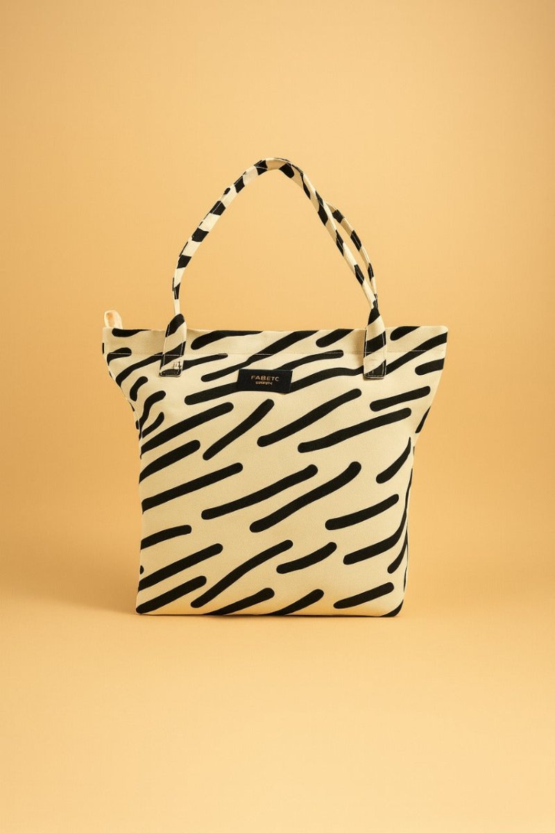 Waterproof fashion handbag, zebra stripe print in black and cream, zip-top tote