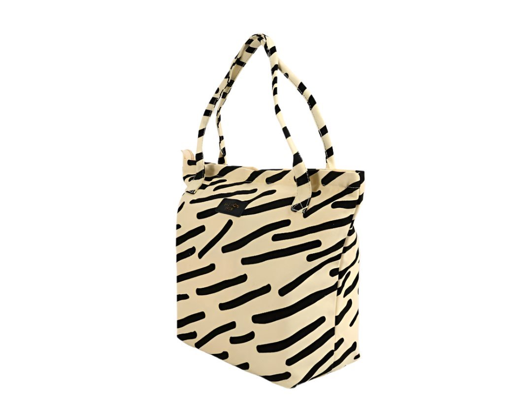 Waterproof fashion handbag with zebra stripe print, black handles, cream base, zip-top tote