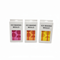 Three packaged ice making moulds, showing pink, orange, and yellow silicone trays