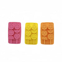 Three silicone ice trays in pink, yellow, and orange with circular mold shapes