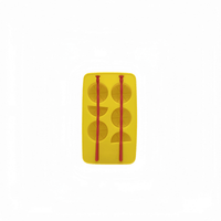 Yellow silicone ice tray with bottle-shaped molds and red ice-cube forms