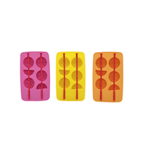 Three silicone ice trays in pink, yellow, and orange with bottle-shaped ice molds