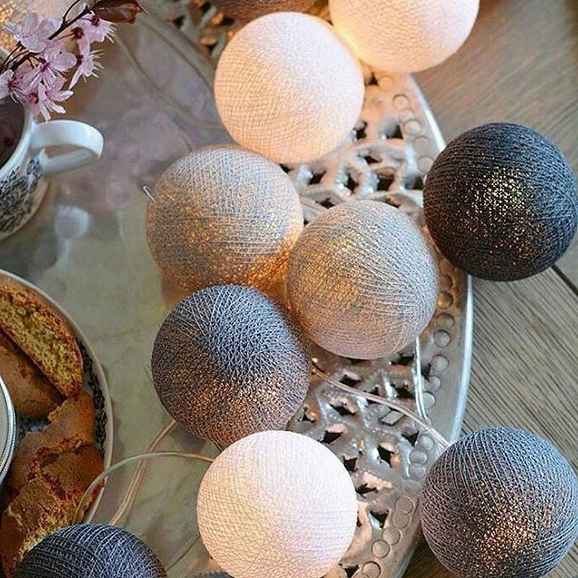 String lights with mixed silver, beige, and blue globe bulbs on wire