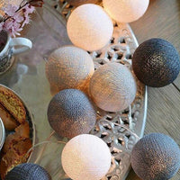 String lights with mixed silver, beige, and blue globe bulbs on wire