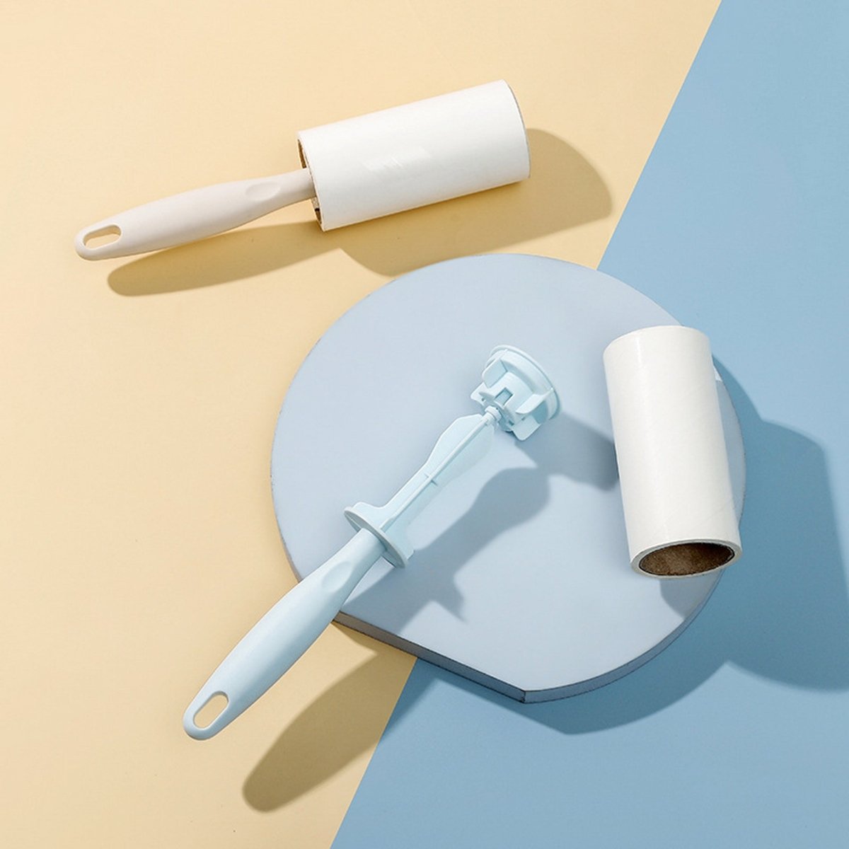 Lint roller with white sticky roll and blue plastic handle, angled for easy use