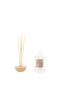 Reed diffuser set with beige reed base, pale reeds, and clear glass bottle with Longfine