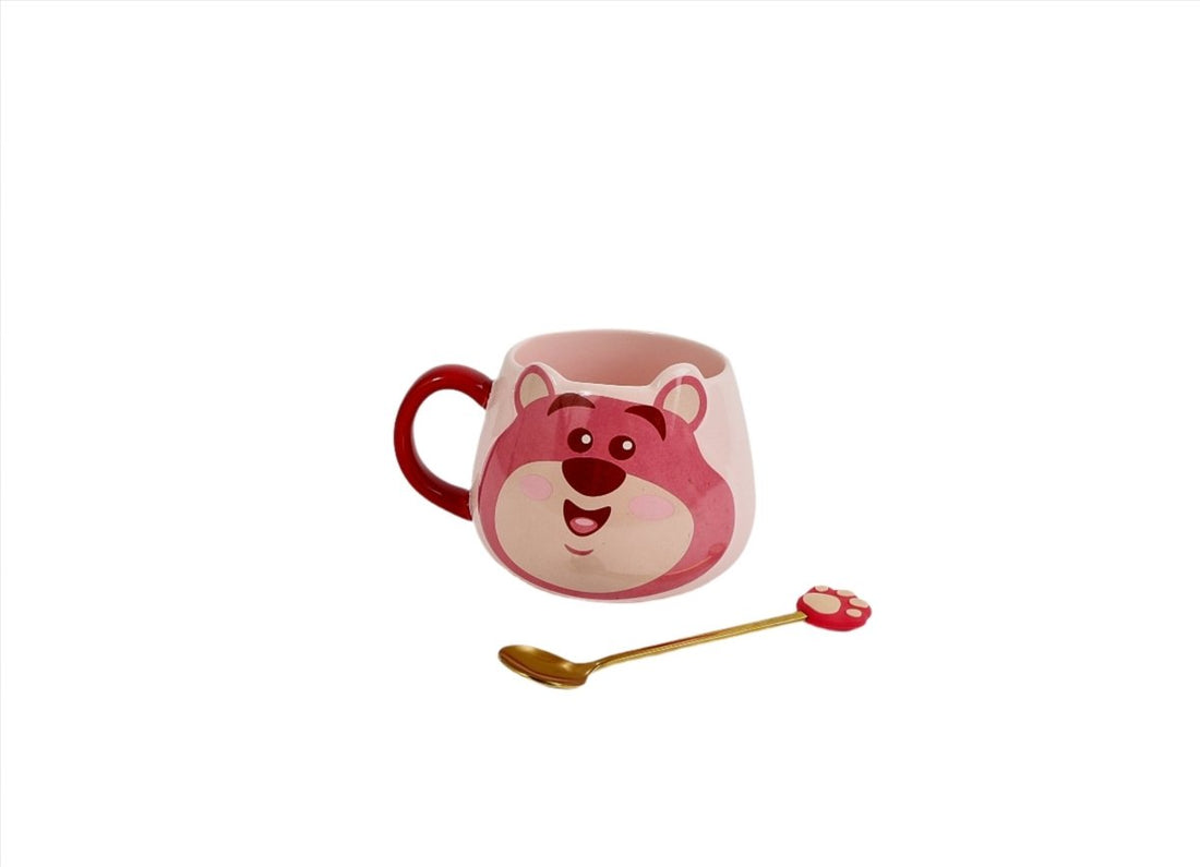 Pink bear-face ceramic mug with red handle and gold spoon plus red paw-shaped topper
