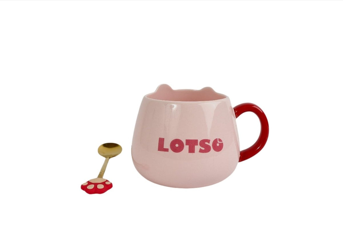 Pink LOTSO ceramic mug with red handle and gold spoon with red paw-shaped end