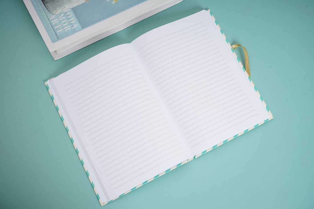 Open lined notebook pages with green-and-white patterned edges