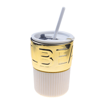 Ceramic coffee cup with lid and white straw, gold lettered band and ribbed body